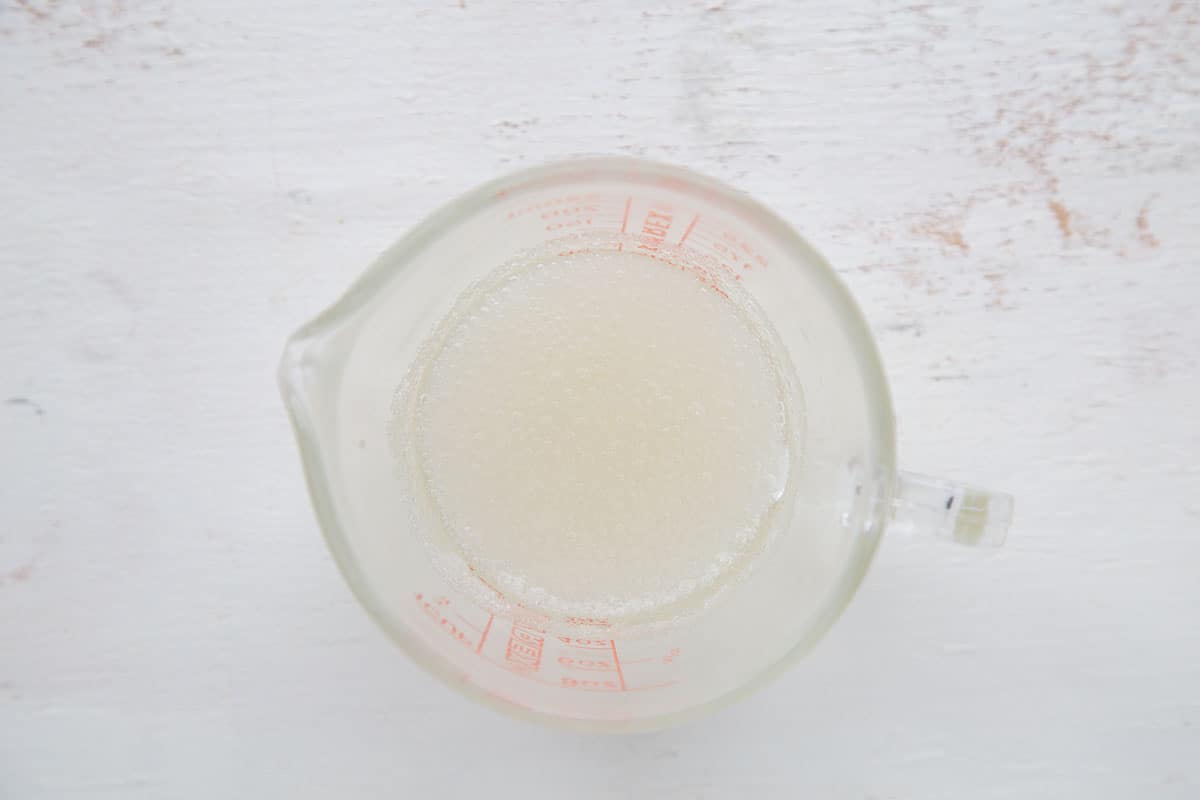 measuring cup with gelatin and water in it.