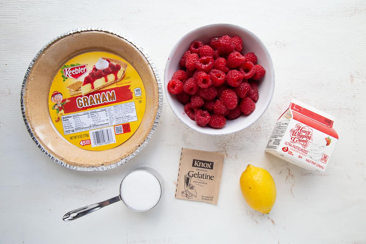 ingredients for raspberry pie on a white table.