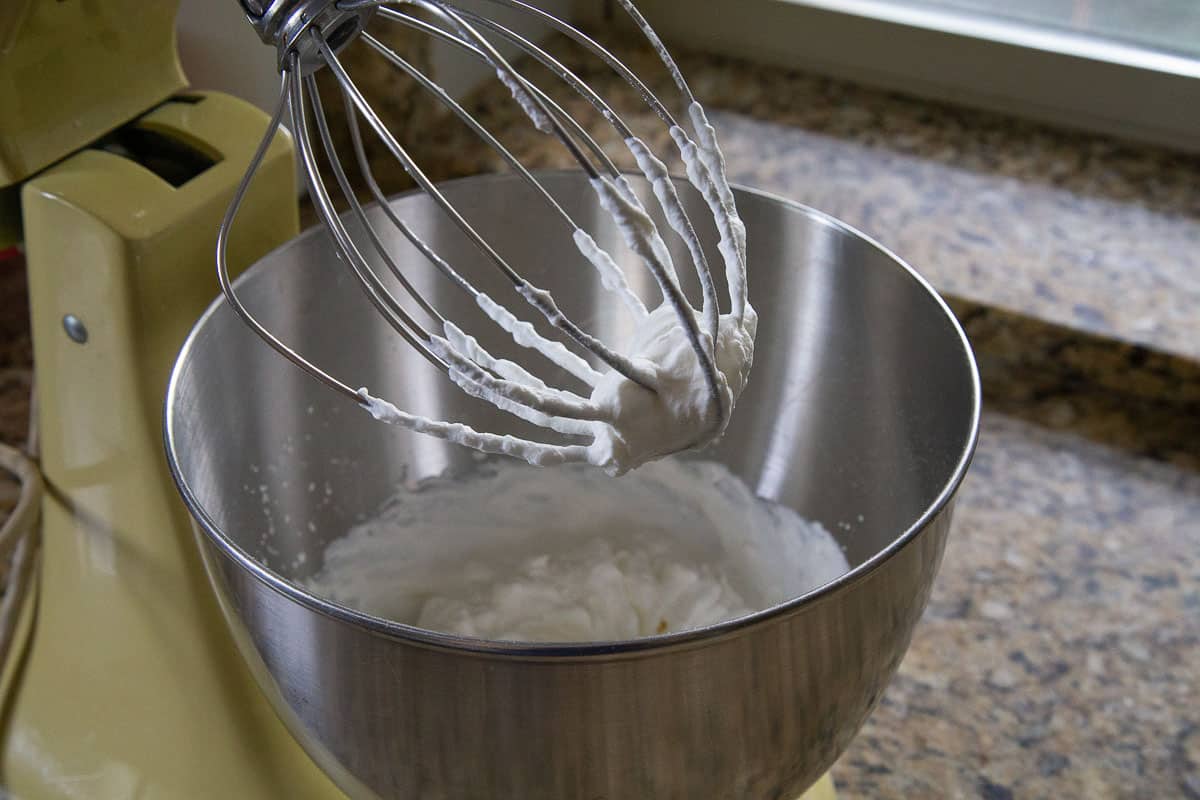 whipped cream in a stand mixer with a whisk attachment.