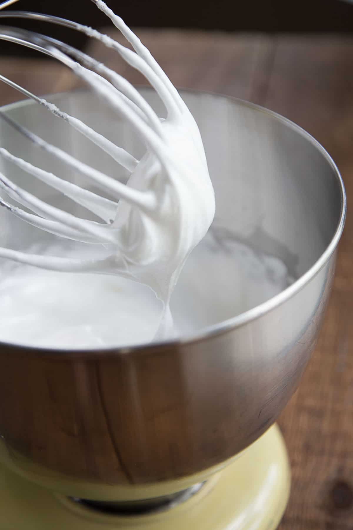 thick, glossy egg whites beaten in a metal bowl.