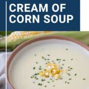 cream of corn soup in a low bowl, topped with corn kernels and chives.