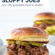 sloppy joe sandwich with pickles on a brioche bun.