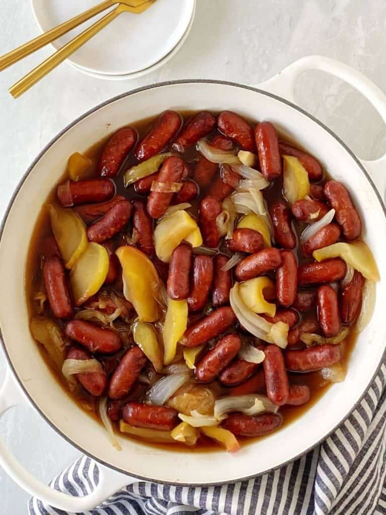 cocktail franks with apple and onions in a large dutch oven.