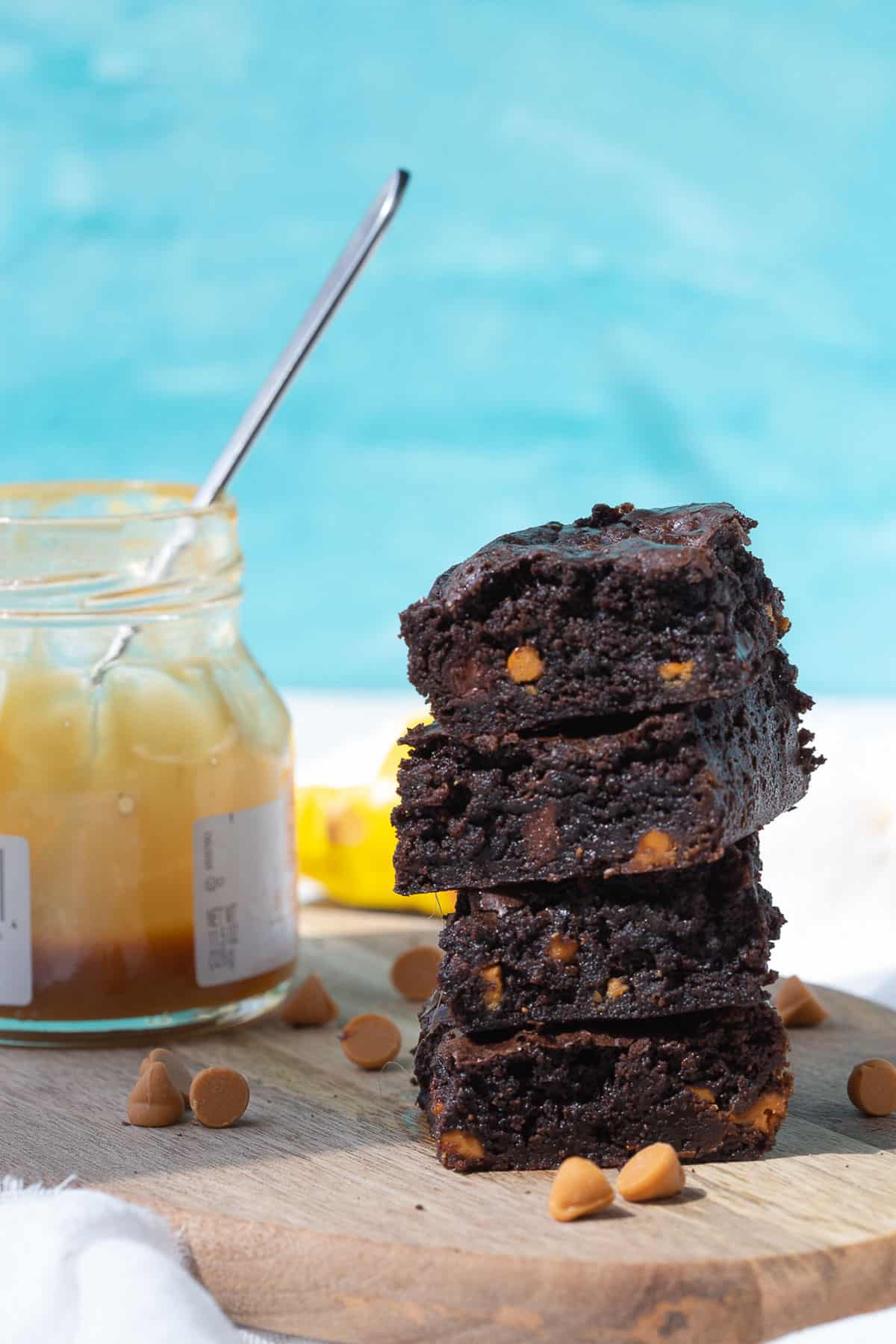 four brownies with butterscotch chips stacked on top of one another.