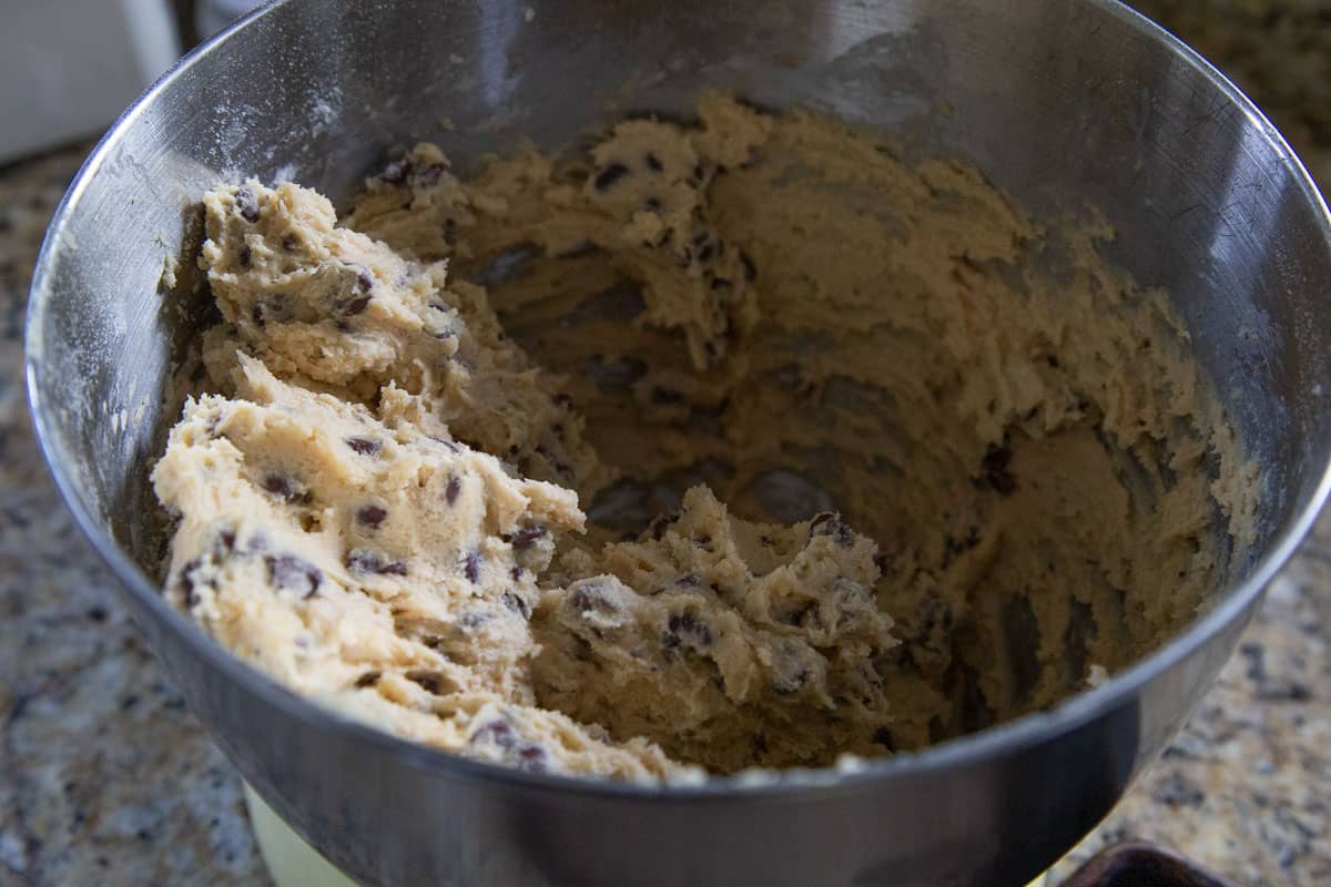 chocolate chip cookie dough in a metal bowl.