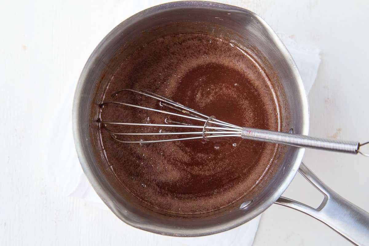 chocolate mixture in a saucepan with a whisk.