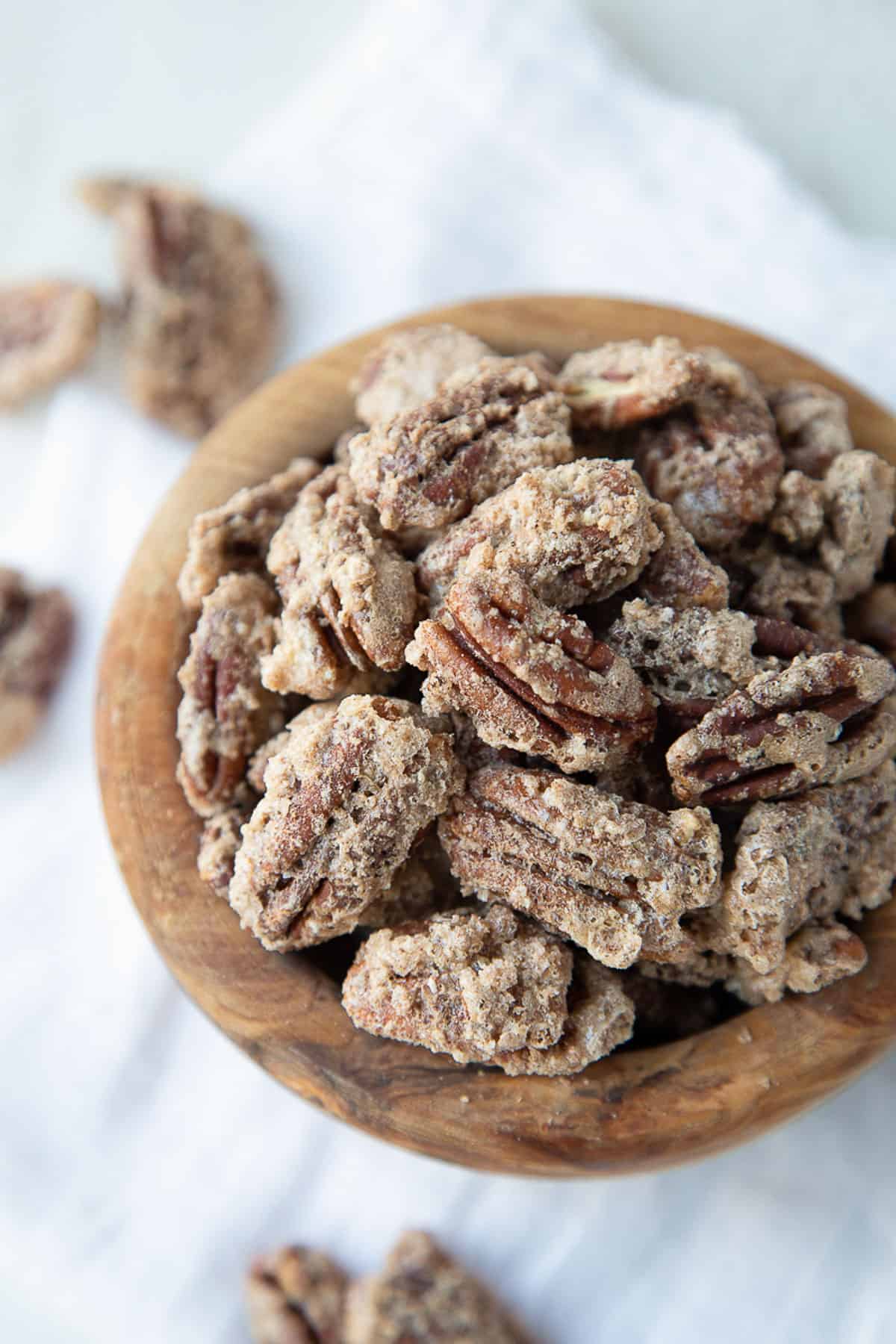 cinnamon roasted pecans in a wooden bowl.