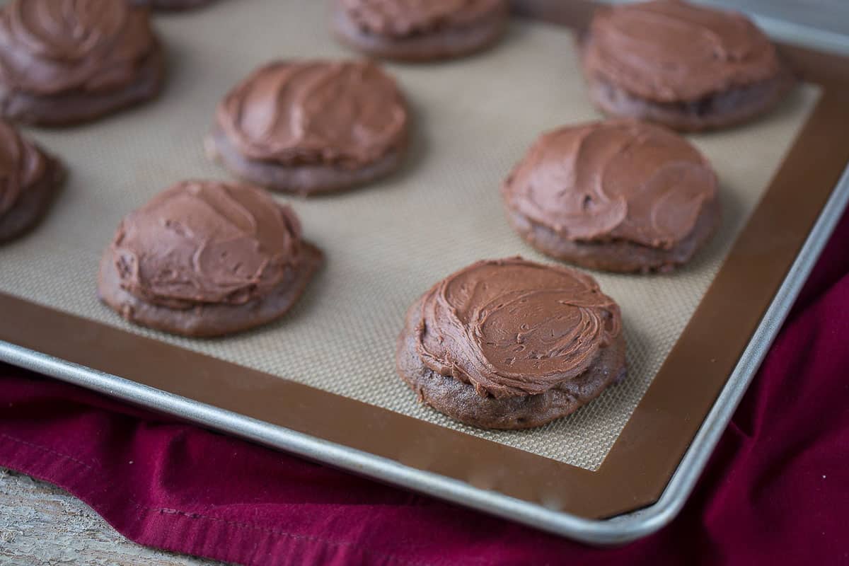 cocoa drop cookies on a silicone baking mat.