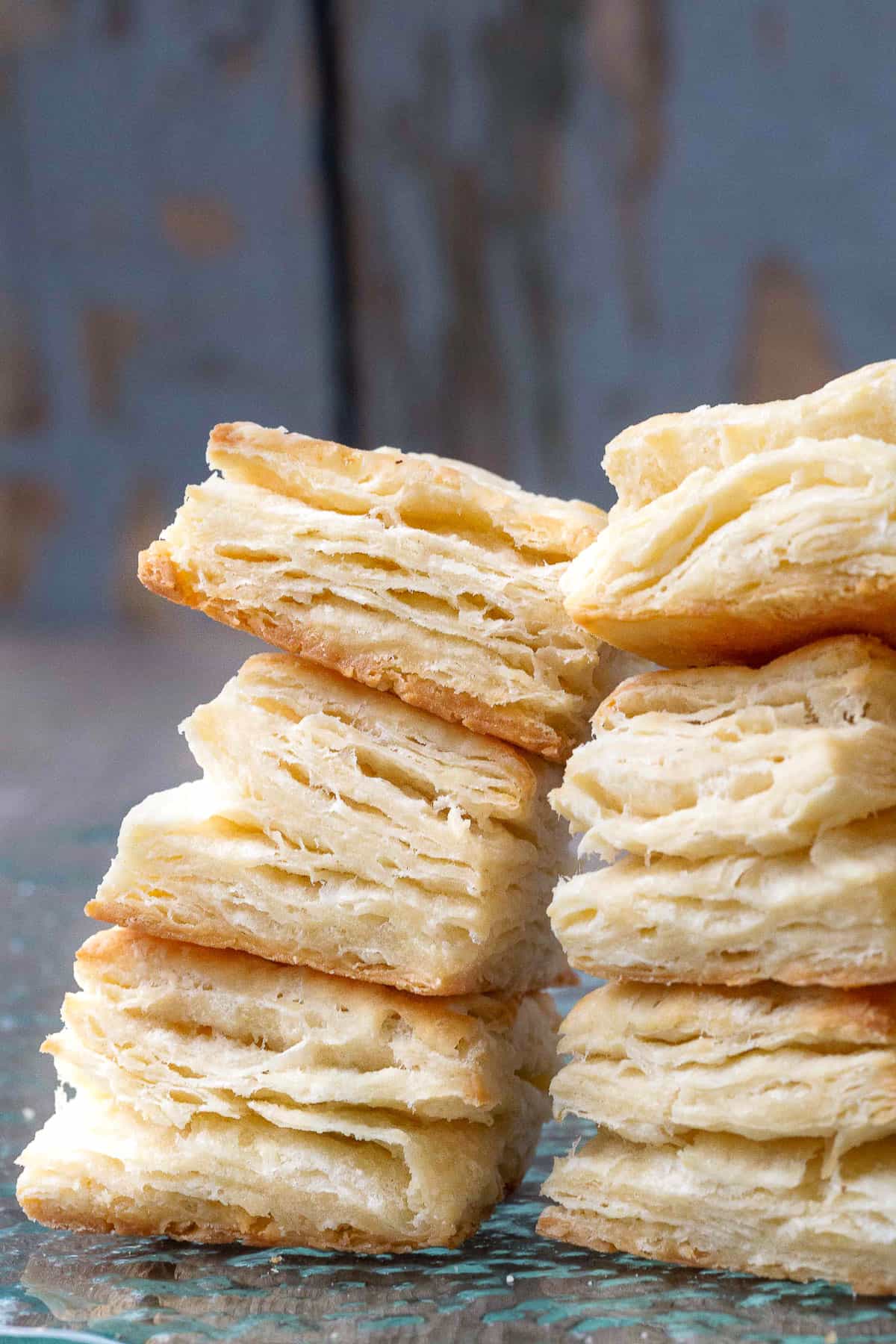 six square biscuits stacked up, with flaky layers visible.