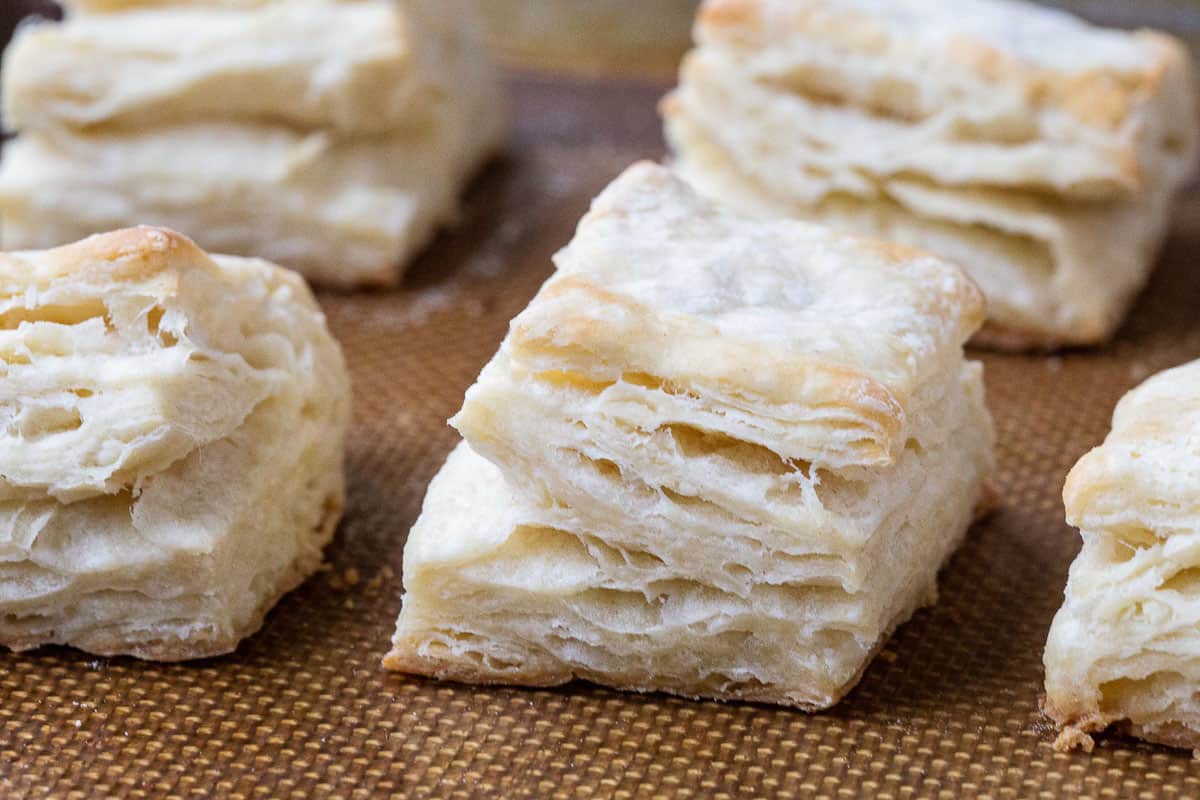 flaky biscuits on a silicone baking mat.