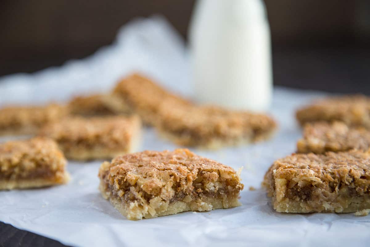 chewy coconut bar cookies on a piece of crumpled white parchment.