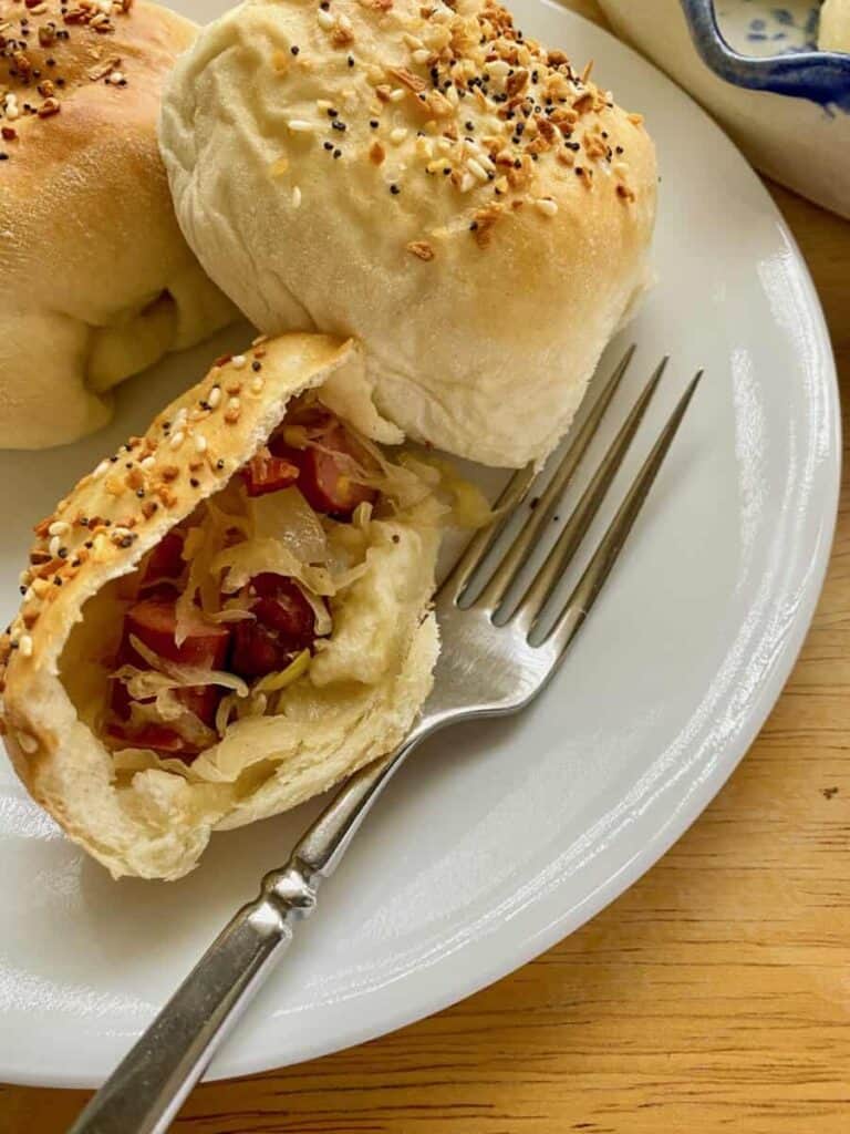 dinner rolls filled inside with cocktail sausages and onions.