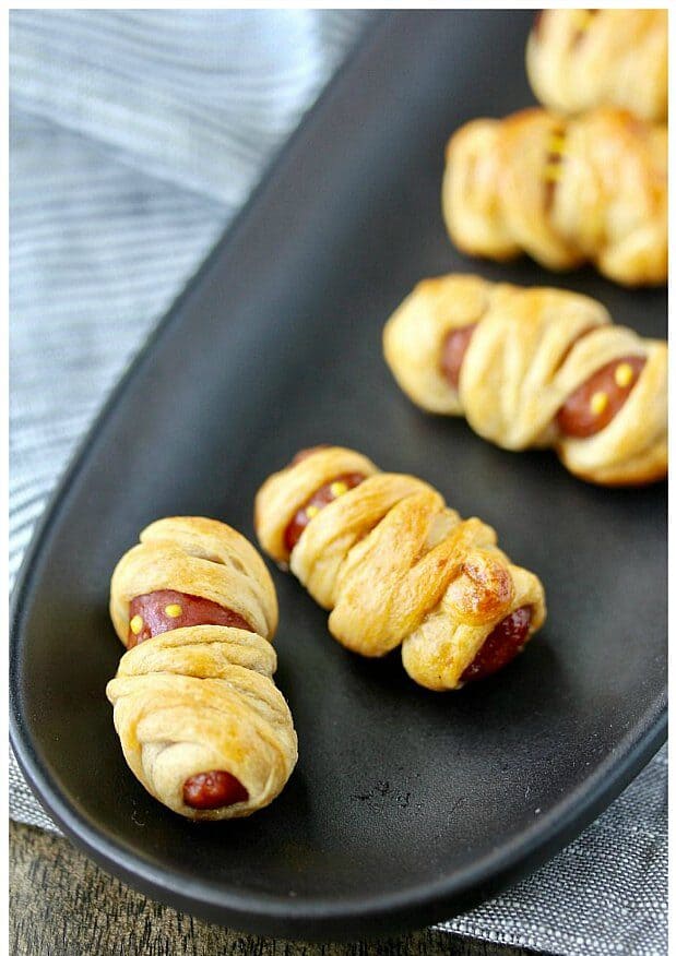 cocktail sausages wrapped in thinly cut crescent rolls to resemble mummies.