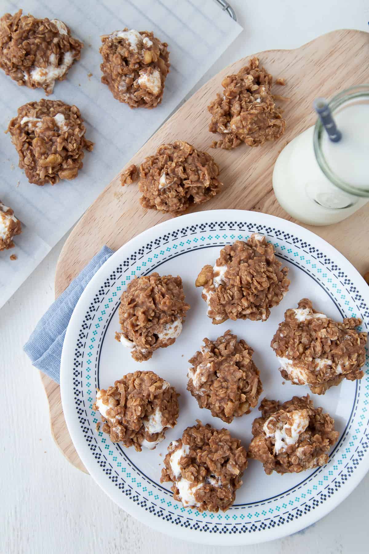 no bake chocolate cookie clusters on a white plate with blue trim.