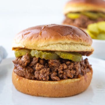 old fashioned sloppy joes meat on a brioche bun with pickles.