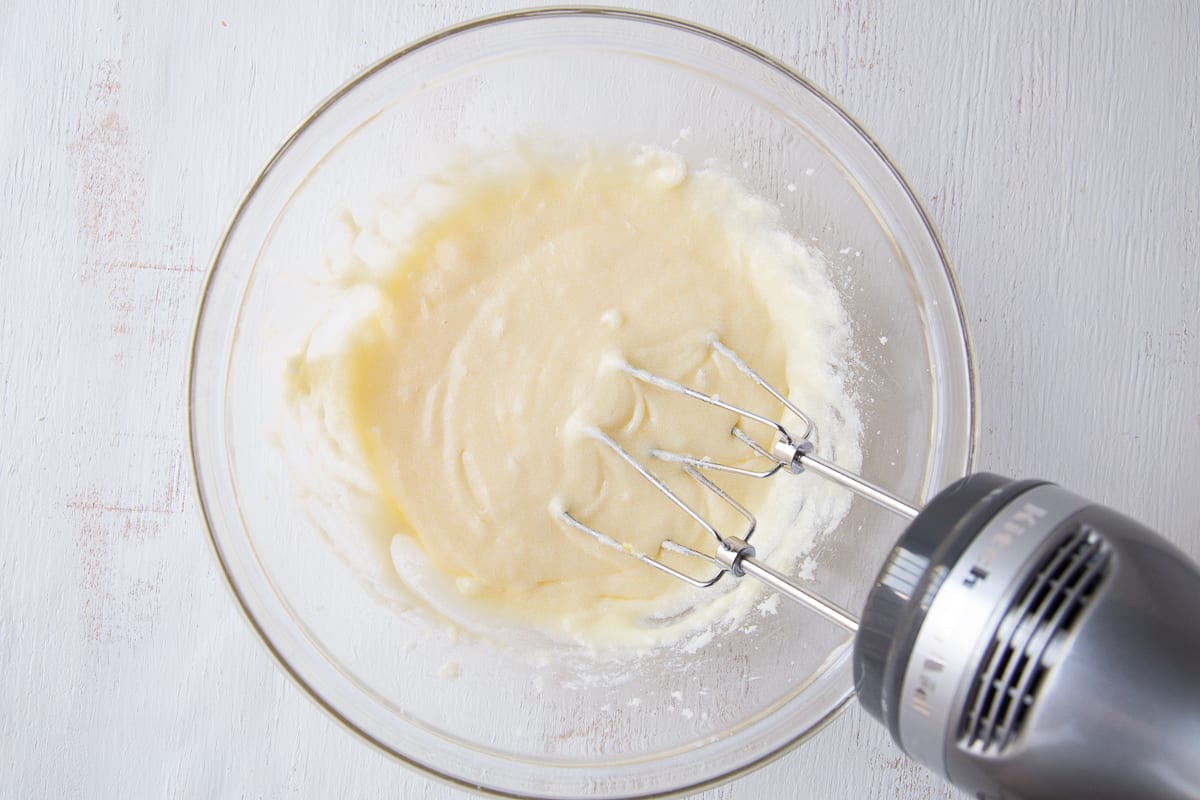 batter for quick bread in a glass bowl with a hand mixer.
