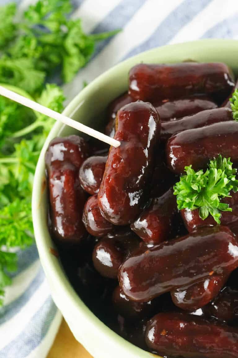 little smokies with a dark brown glaze in a bowl.