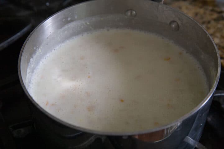corn kernels in milk in a saucepan.
