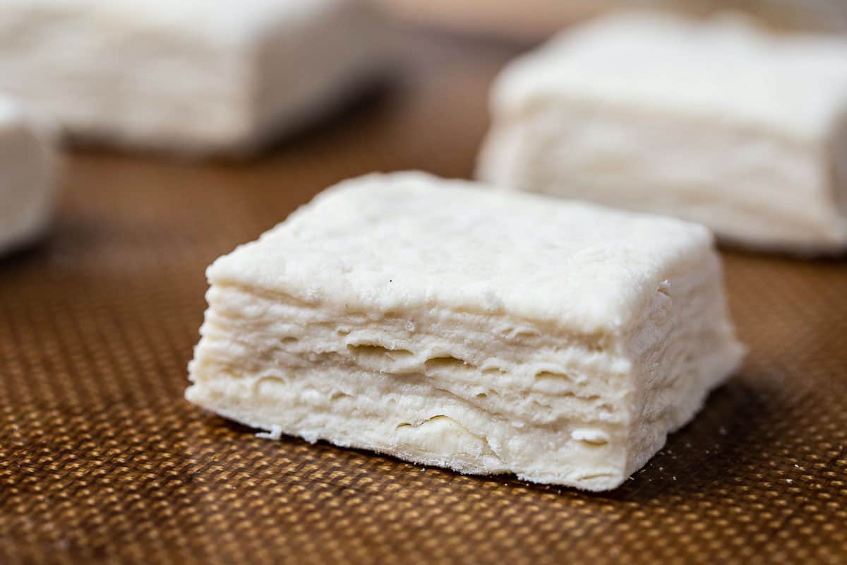 uncooked biscuit on a silicone baking mat.