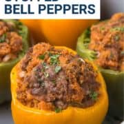 stuffed peppers in a gray casserole dish.