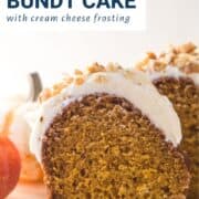 slice of pumpkin bundt cake topped with cream cheese frosting and walnuts.
