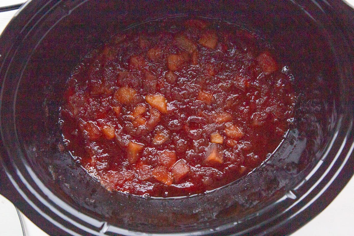 soft apple chunks in a brown sauce in a crockpot.