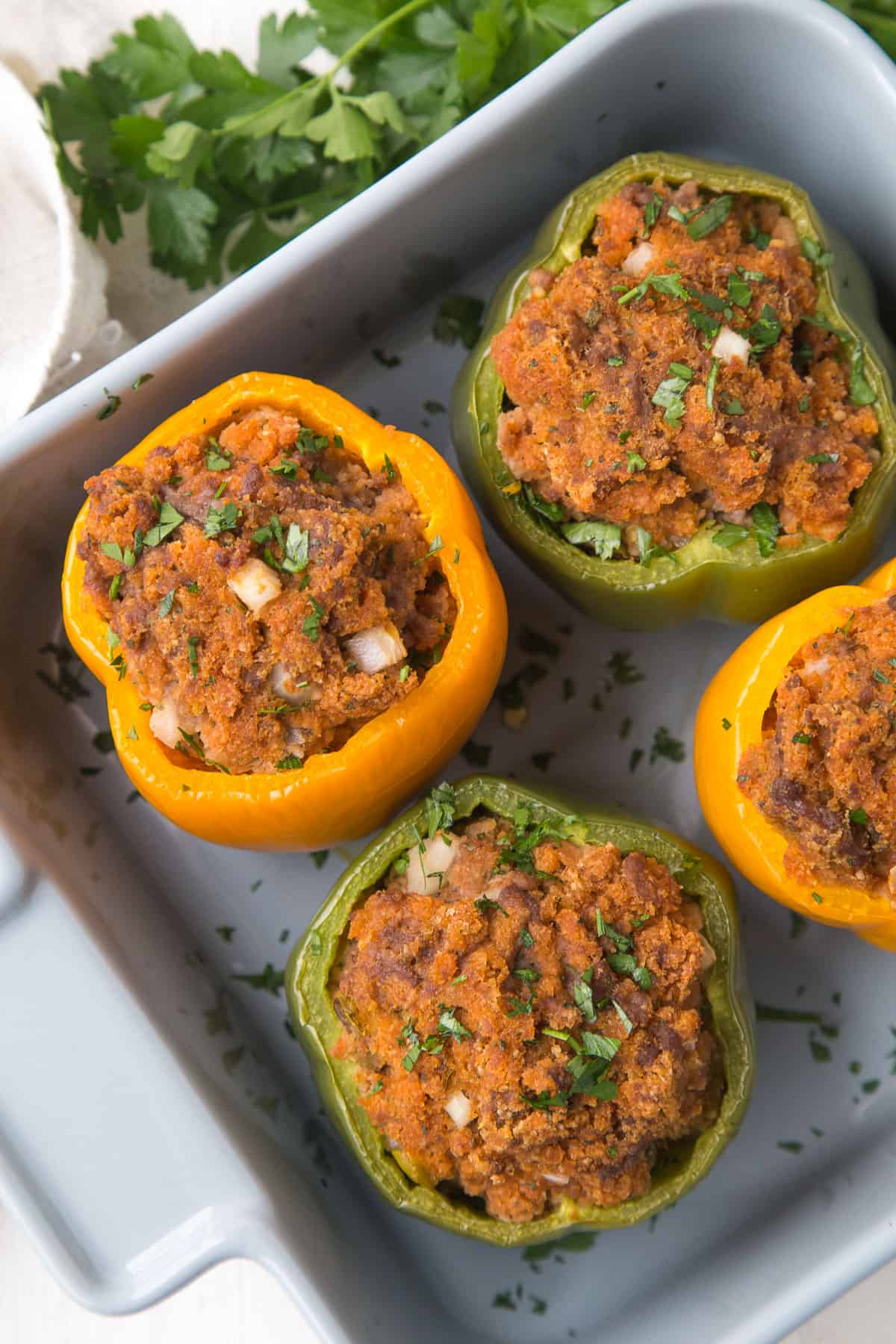beef stuffed bell peppers in a gray casserole dish.