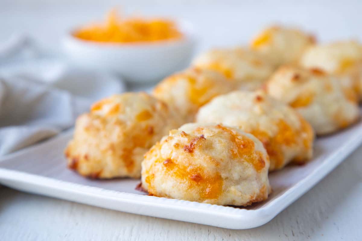 cheddar biscuits on a white serving platter.