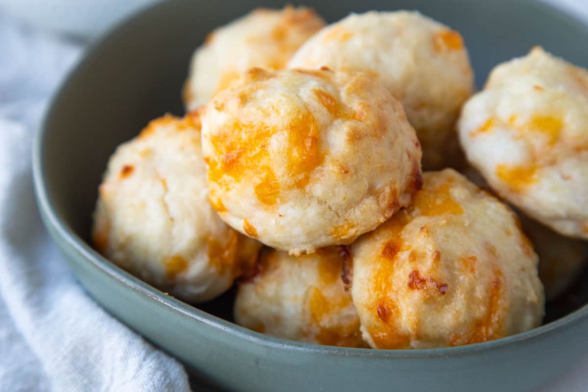 bisquick cheddar biscuits in a low green bowl.