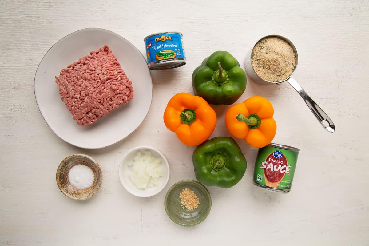 ingredients for stuffed peppers on a white table.