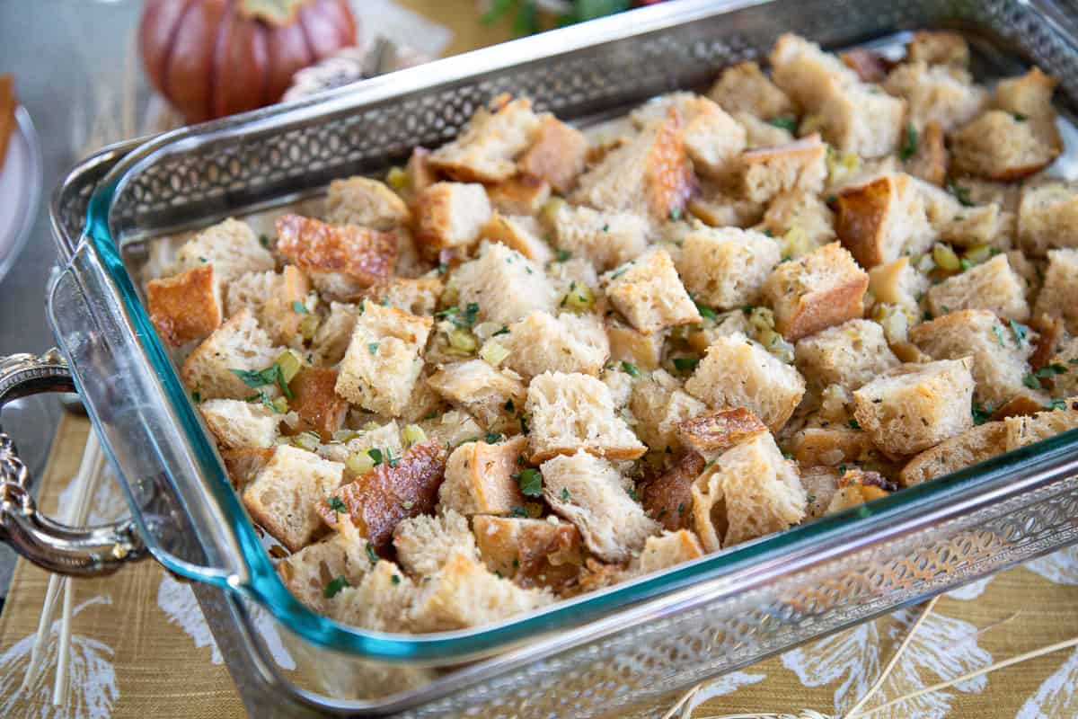 sourdough stuffing in a glass casserole dish in a metal casserole serving tray.