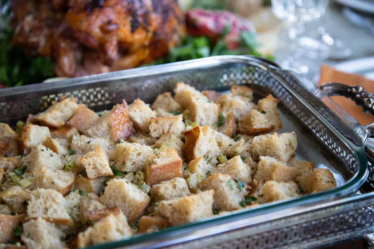 stuffing in a glass casserole dish topped with fresh parsley.