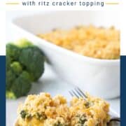 scoop of cheesy broccoli casserole topped with cracker crumbs on a white plate with a fork.