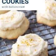 sour cream cookies topped with frosting and gold sprinkles on a wire rack.