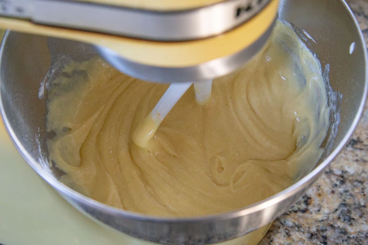 cake batter in the metal bowl of a stand mixer.