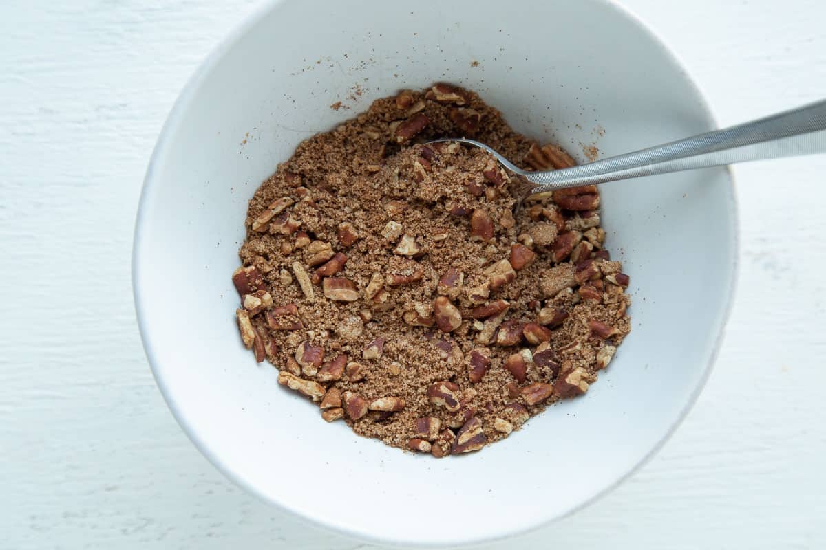 pecans and brown sugar in a small white bowl.