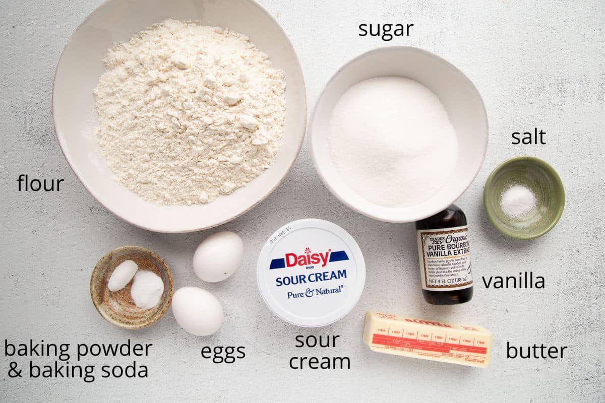 sour cream, flour, sugar, and other ingredients on a white table.