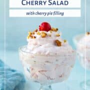 Cherry Salad in a glass parfait dish, topped with cherries and nuts.