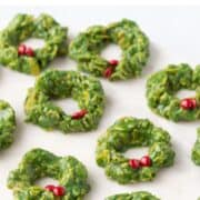 corn flake wreaths with mini red M&Ms for holly on a white platter.