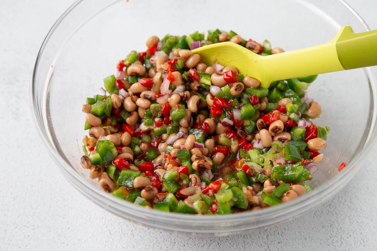 glass bowl filled with black eyed peas and veggies.