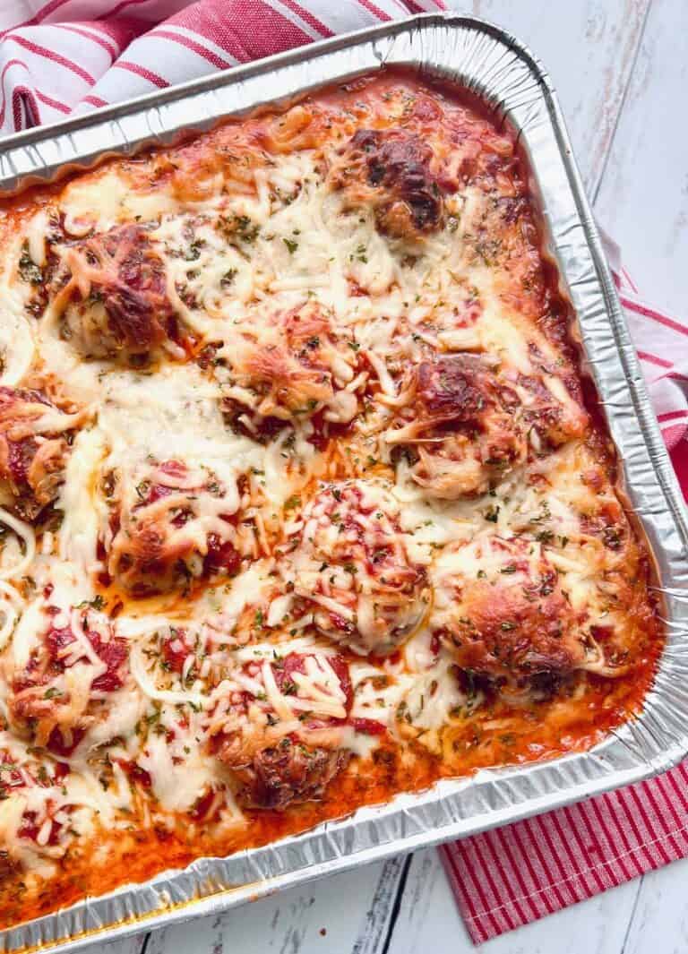 baked ziti with meatballs and melted mozzarella in a foil pan.