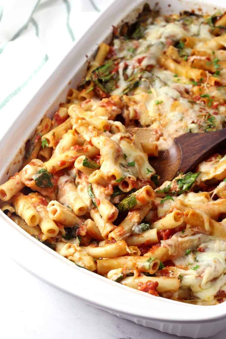 baked ziti with spinach in a casserole dish.