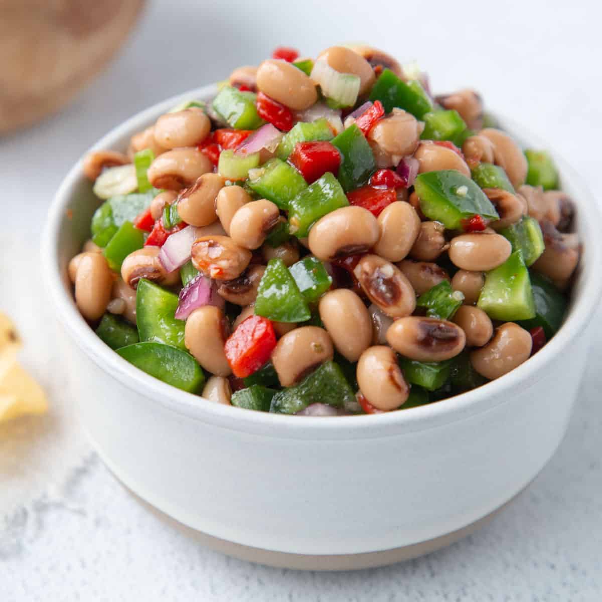 black eyed pea dip in a small round white bowl.