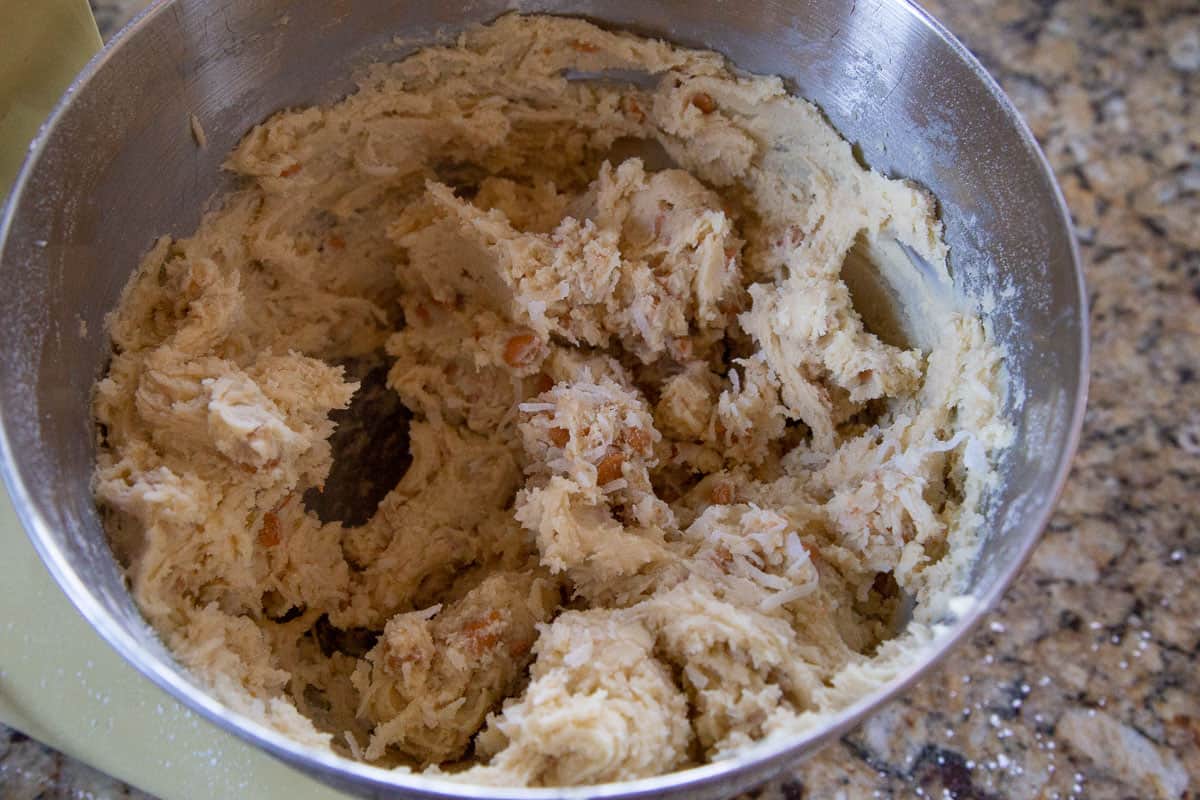 cookie dough in a metal bowl of a stand mixer.