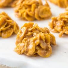 corn flake candy clusters on a white marble tray.