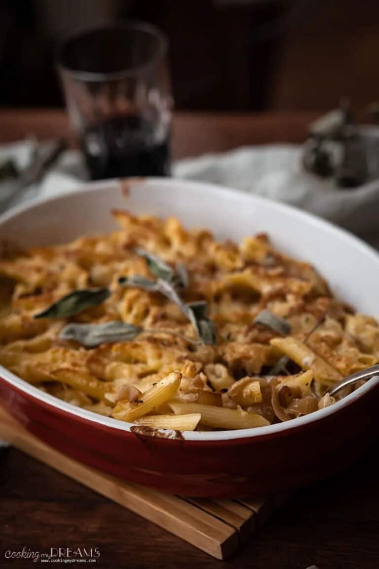french onion pasta in a casserole dish, topped with fresh sage.