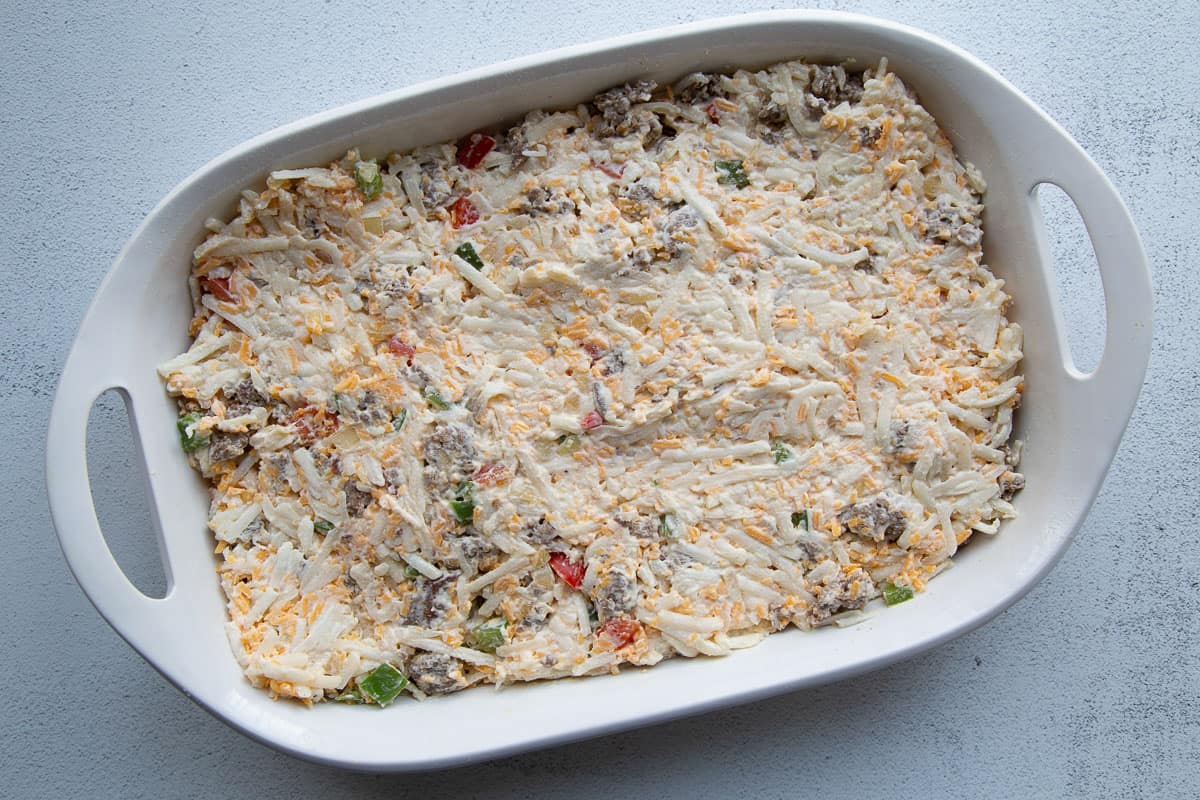 uncooked hash brown mixture in a casserole dish.