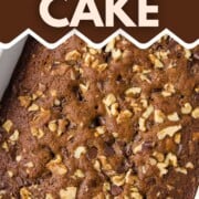 date cake in a white pan topped with walnuts and chocolate chips.