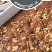whole date cake topped with walnut pieces and chocolate chips baked in.