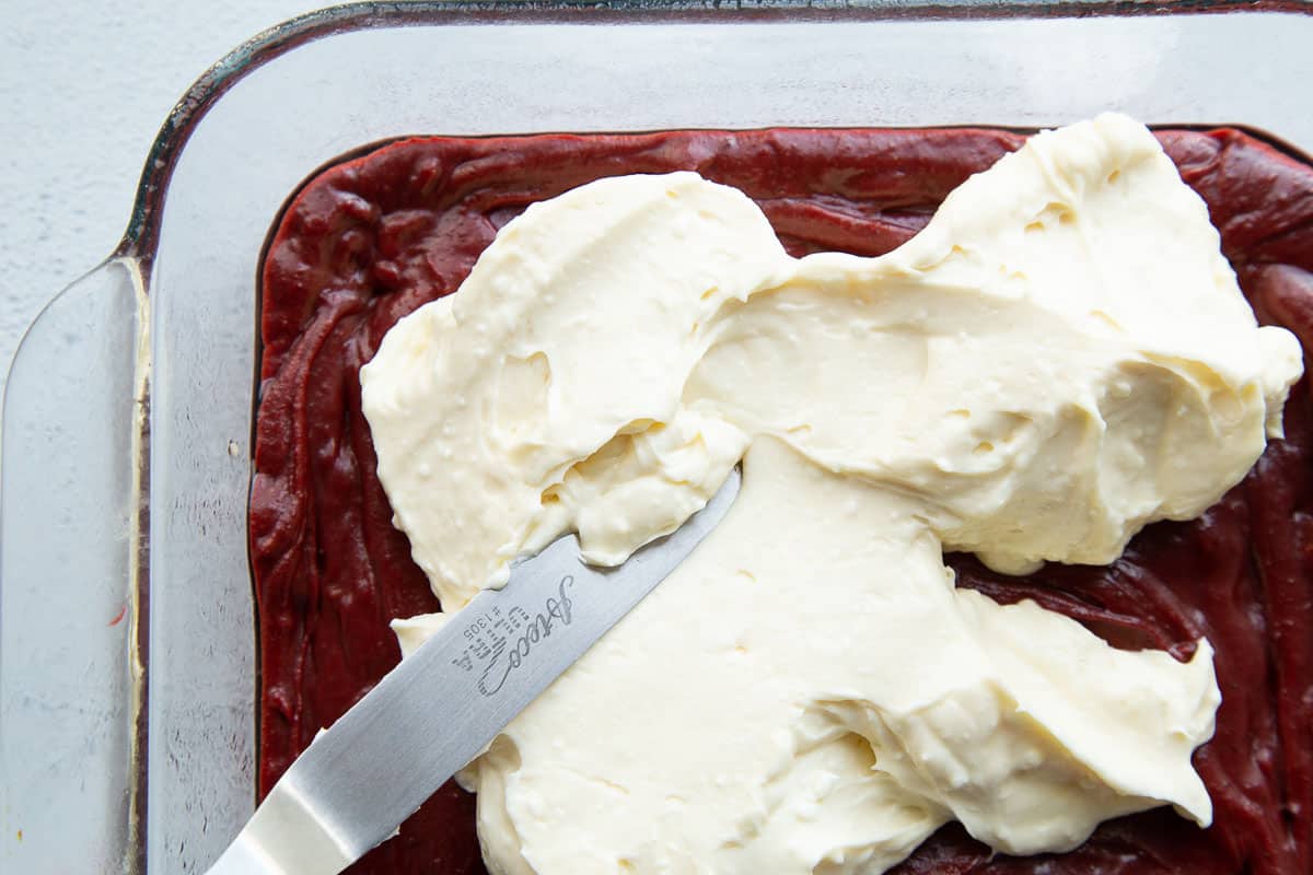 offset spatula spreading a cream cheese mixture.